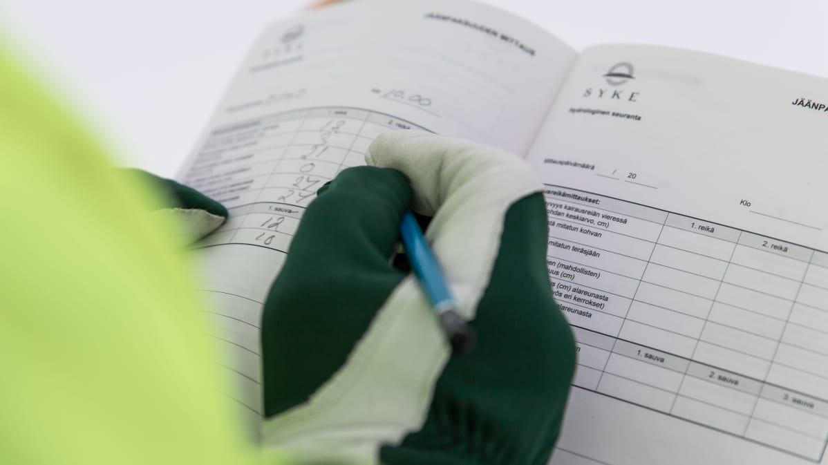 Heimo Pukkila kirjaa jäänpaksuuden muistiin ja toimittaa tiedot Suomen ympäristökeskukselle.