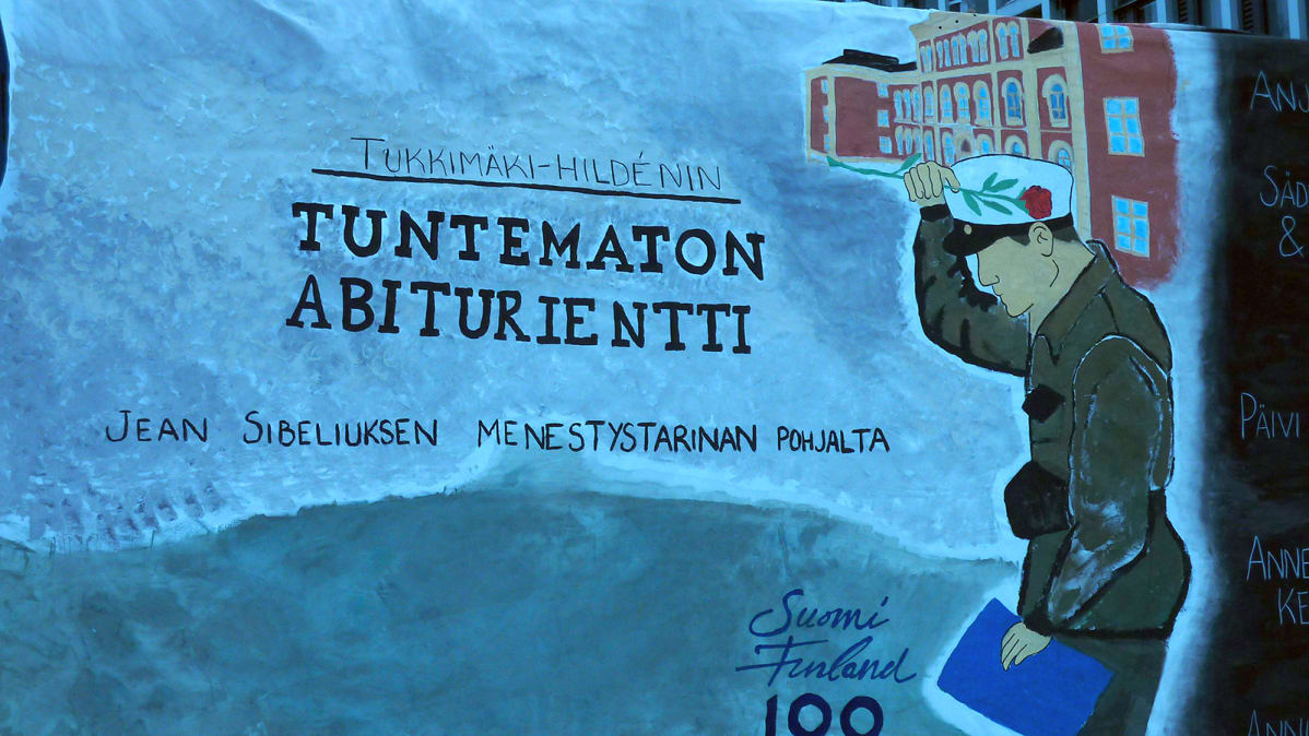 Tuntematon abiturientti -lakana abikuorma-auton kyljessä