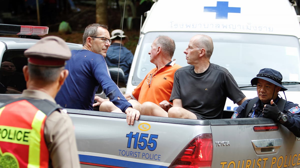 Brittiläiset John Volanthen (vas) ja Richard William Stanton (oik) istuvat poliisiauton lavalla luolan lähellä Thaimaassa.