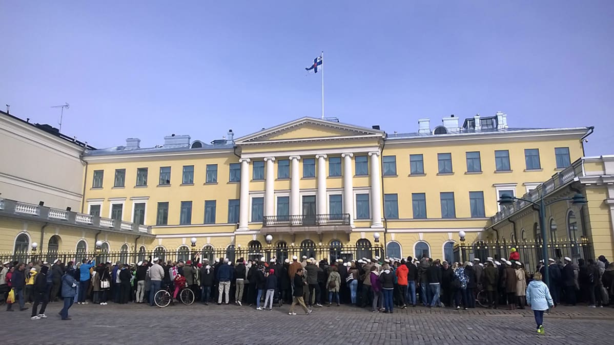 Väkeä presidentinlinnan edustalla.