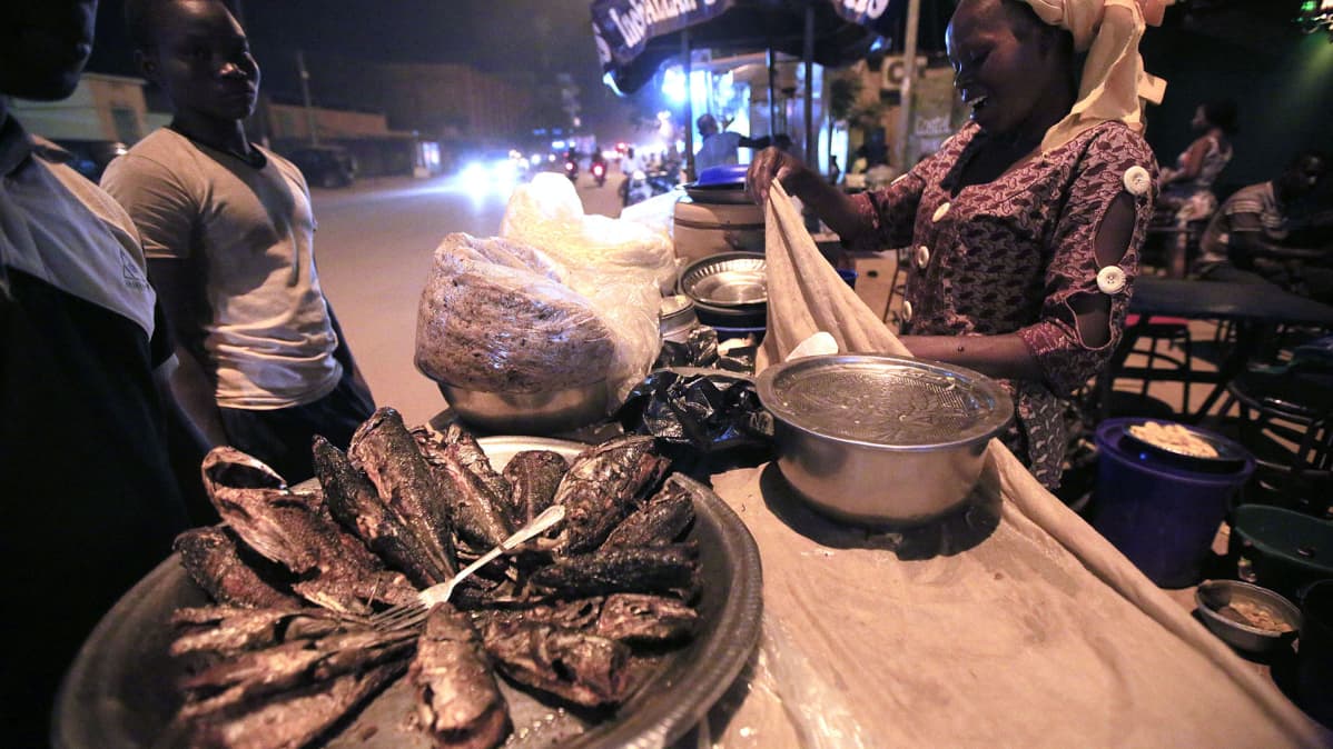 Nainen myy ruokaa kojusta tien varrella Ouagadougoussa, Burkina Fasossa.