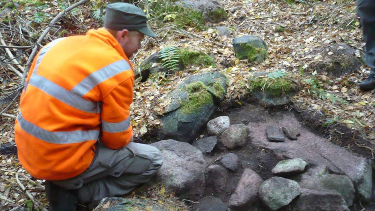 Arkeologi Jasse Tiilikkala tutkii Janakkalan Hangastenmäellä avattua miekan ponnen löytöpaikkaa