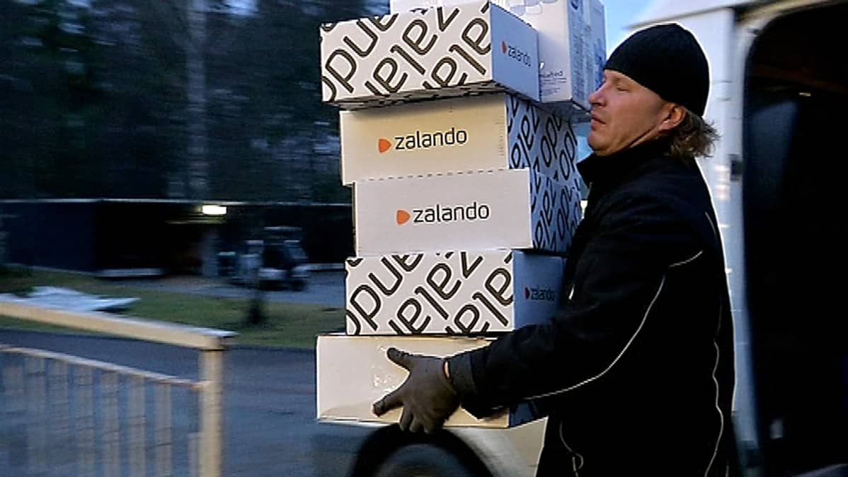 Matkahuollon paketteja kannetaan Siwaan, josta asiakkaat käyvät pakettinsa hakemassa.