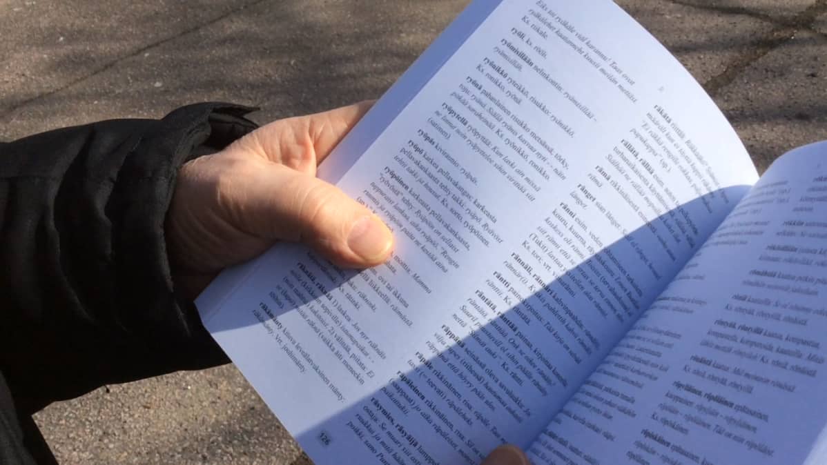 Mies selaa Sippolan sanat-kirjaa