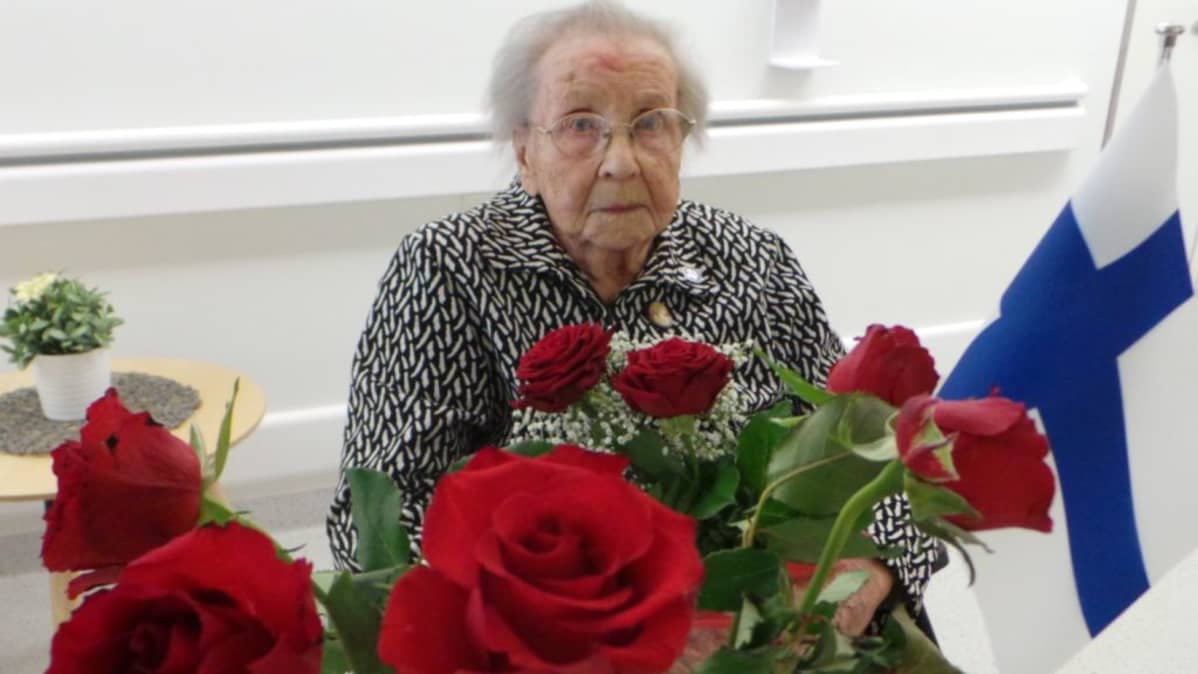 Helmi Taimi kukkia sylissään
