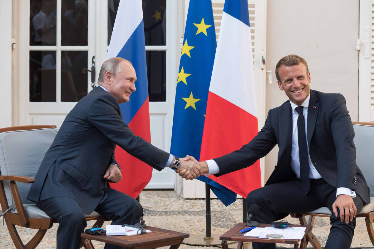 Putin Vierailee Ranskassa. Vladimir Putin ja Emmanuel Macron kättelevät