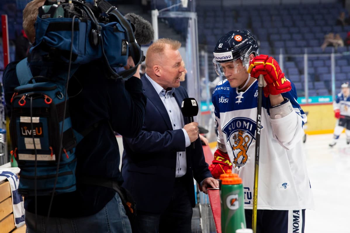 Harri Pesonen on kuvassa Ylen kiekkotoimittaja Jussi Saarisen pihdeissä.