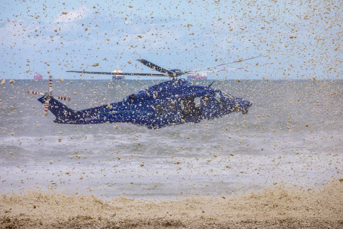 Poliisin helikopteri hajottaa vaahtomattoa Scheveningenissä Hollannissa 14.5.2020.