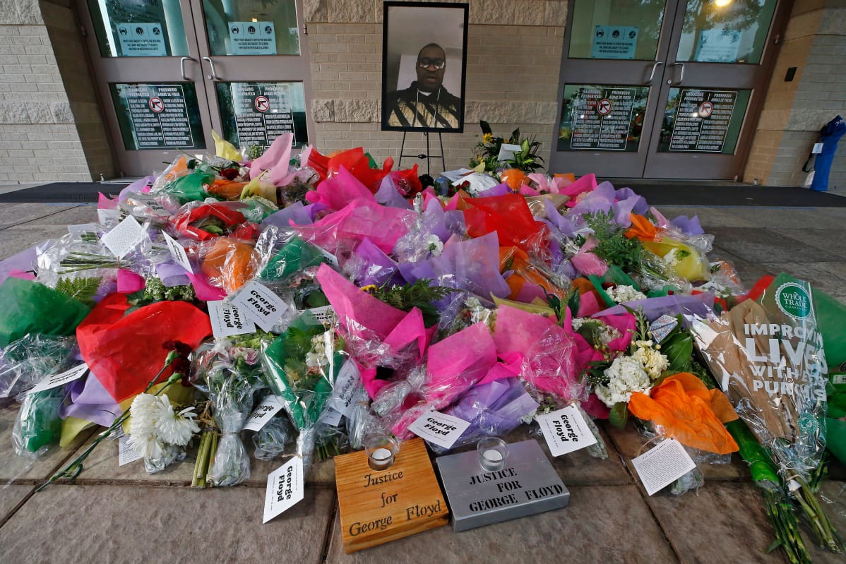 George Floyd Public Viewing in Houston
epa08474740 Flowers below a picture of George Floyd outside The Fountain of Praise Church before the funeral service for George Floyd in Houston, Texas, USA, 09 June 2020. A bystander's video posted online on 25 May, appeared to show George Floyd, 46, pleading with arresting officers that he couldn't breathe as an officer knelt on his neck. The unarmed Black man later died in police custody and all four officers involved in the arrest have been charged and arrested. EPA-EFE/LARRY W. SMITH