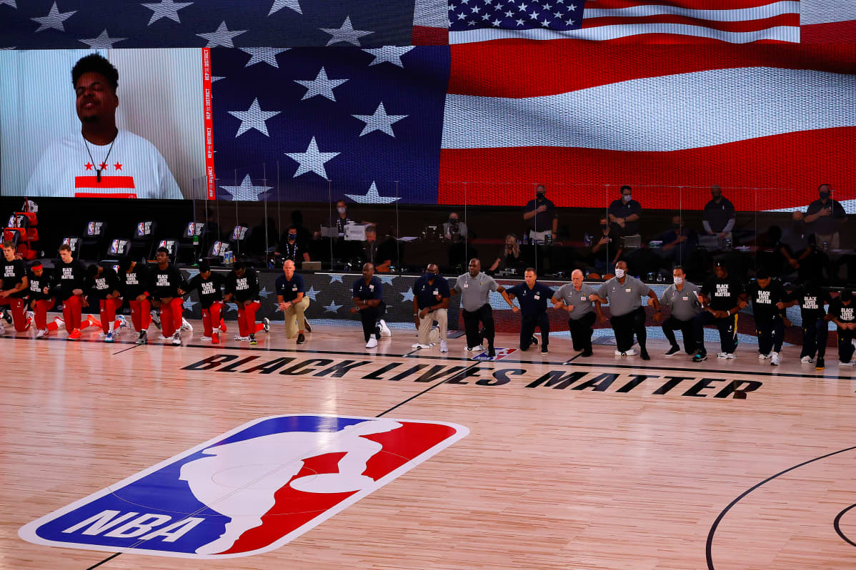 LAKE BUENA VISTA, FLORIDA - AUGUST 03: Indiana Pacers and Washington Wizards take to their knee during the playing of the National Athem at Visa Athletic Center at ESPN Wide World Of Sports Complex on August 03, 2020 in Lake Buena Vista, Florida. NOTE TO USER: User expressly acknowledges and agrees that, by downloading and or using this photograph, User is consenting to the terms and conditions of the Getty Images License Agreement. (Photo by Mike Ehrmann/Getty Images)