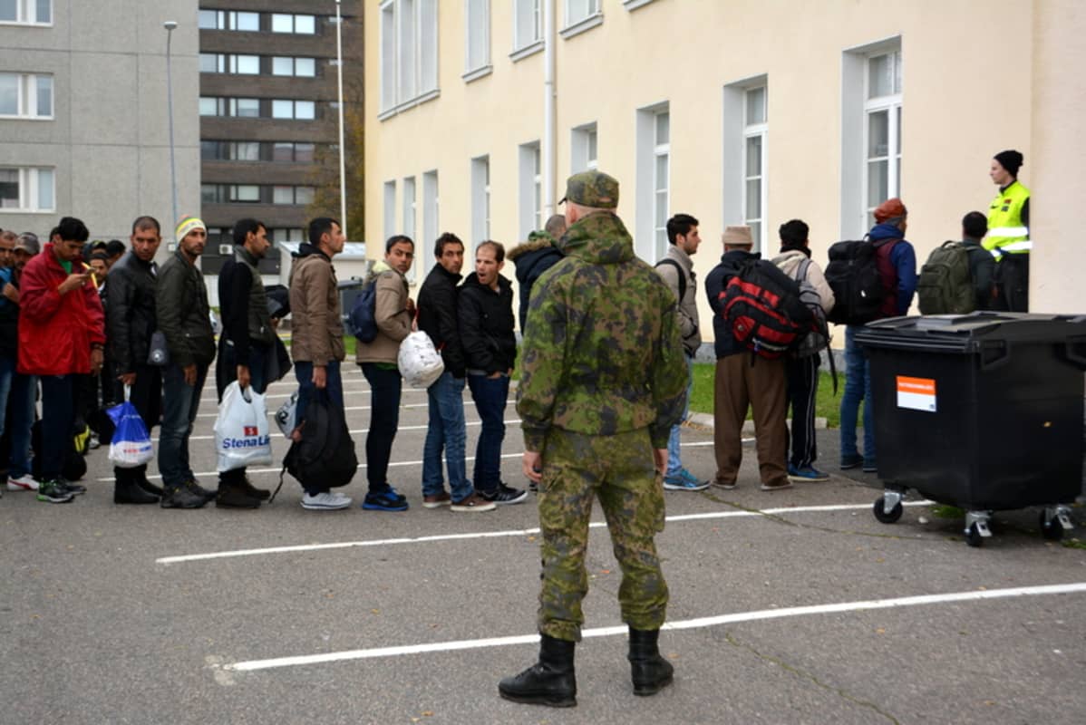 Turvapaikanhakijat jonottavat pääsyä Tornion järjestelykeskuksessa.