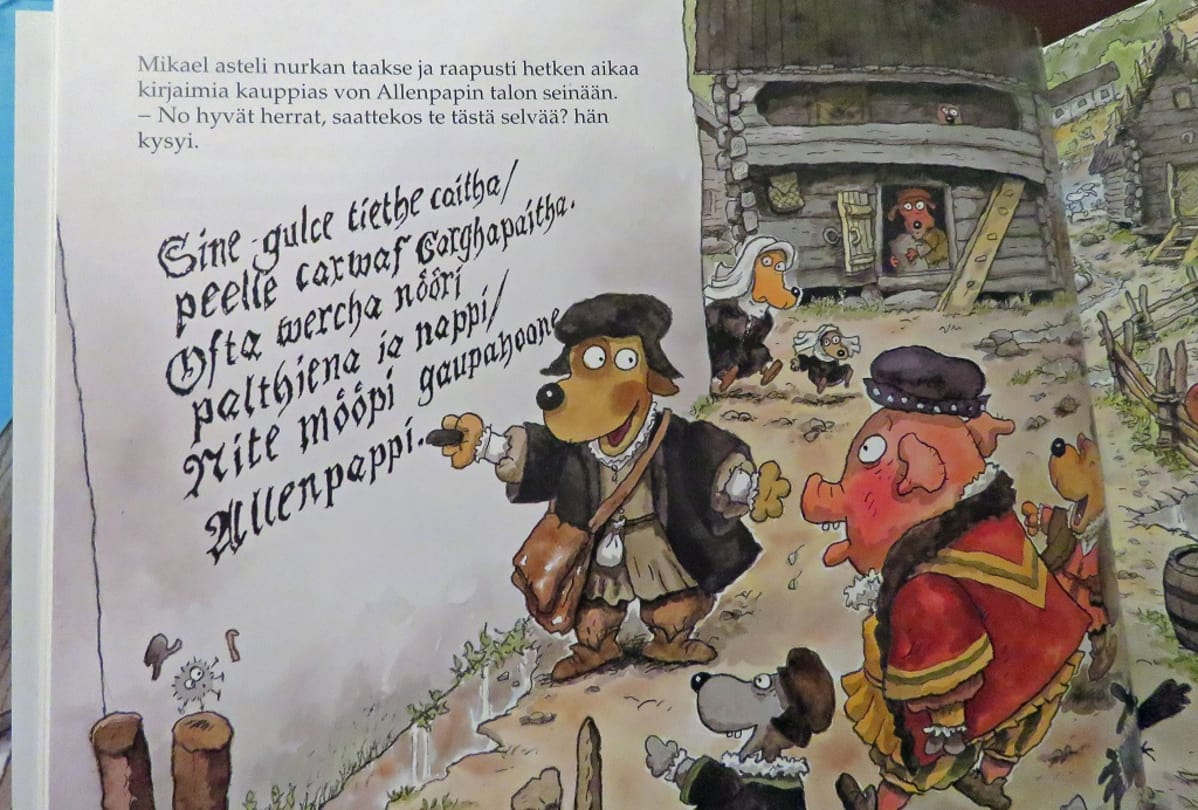 Aukeama, jossa Kunnaksen koirahahmoinen Mikael Acrigola kirjoittaa hiilellä seinään ja ympärillä muut eläimet ällistelevät.