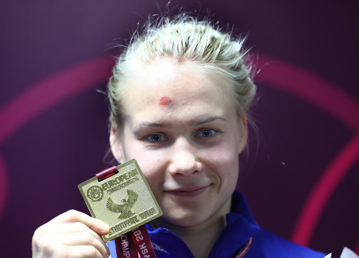 Petra Olli posereaa EM-kultamitalin kanssa.
