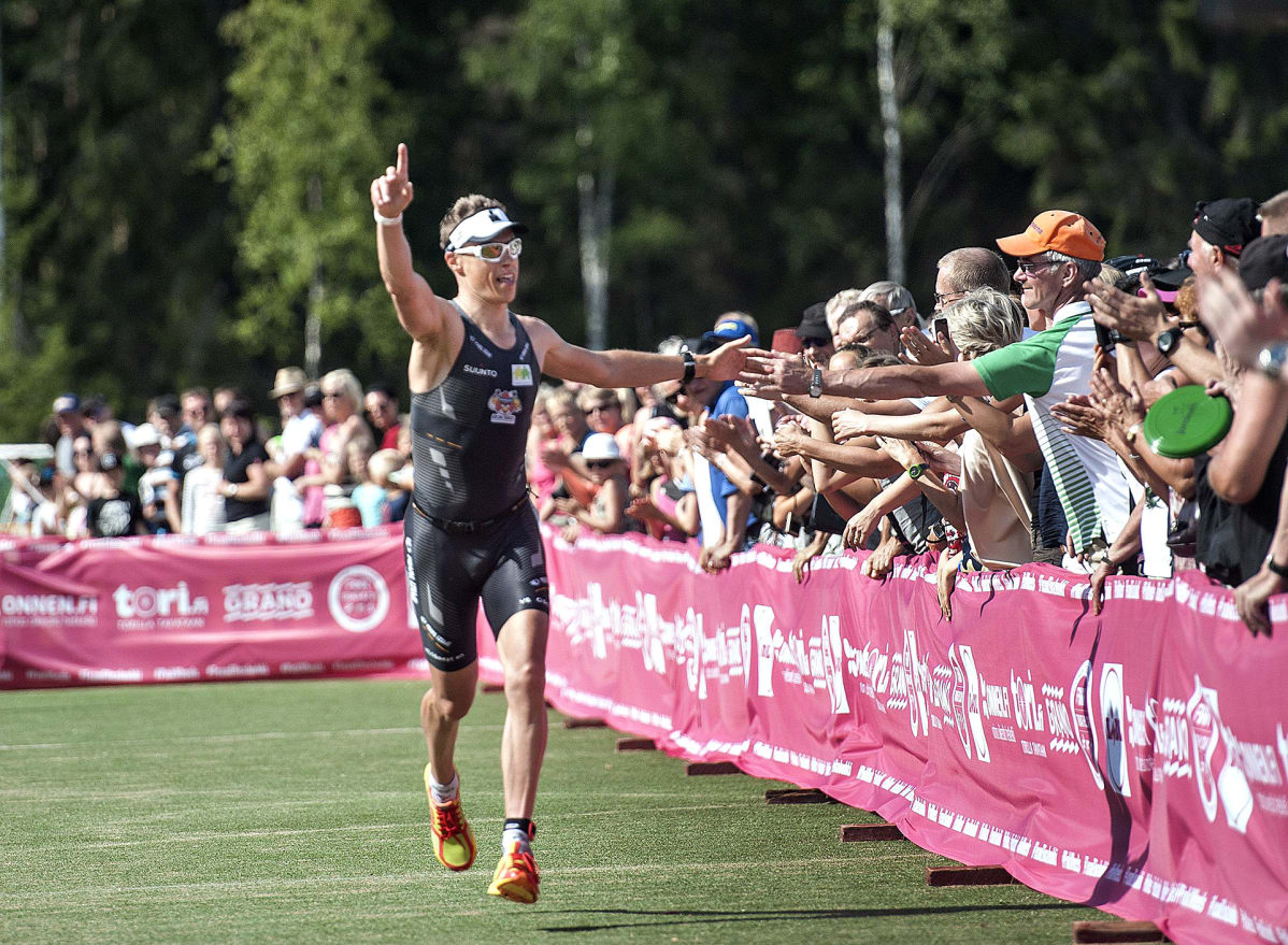 Pääministeri Alexander Stubb saapumassa maaliin juoksuosuudelta triathlonin SM-kilpailuissa Joroisissa 19. heinäkuuta 2014.