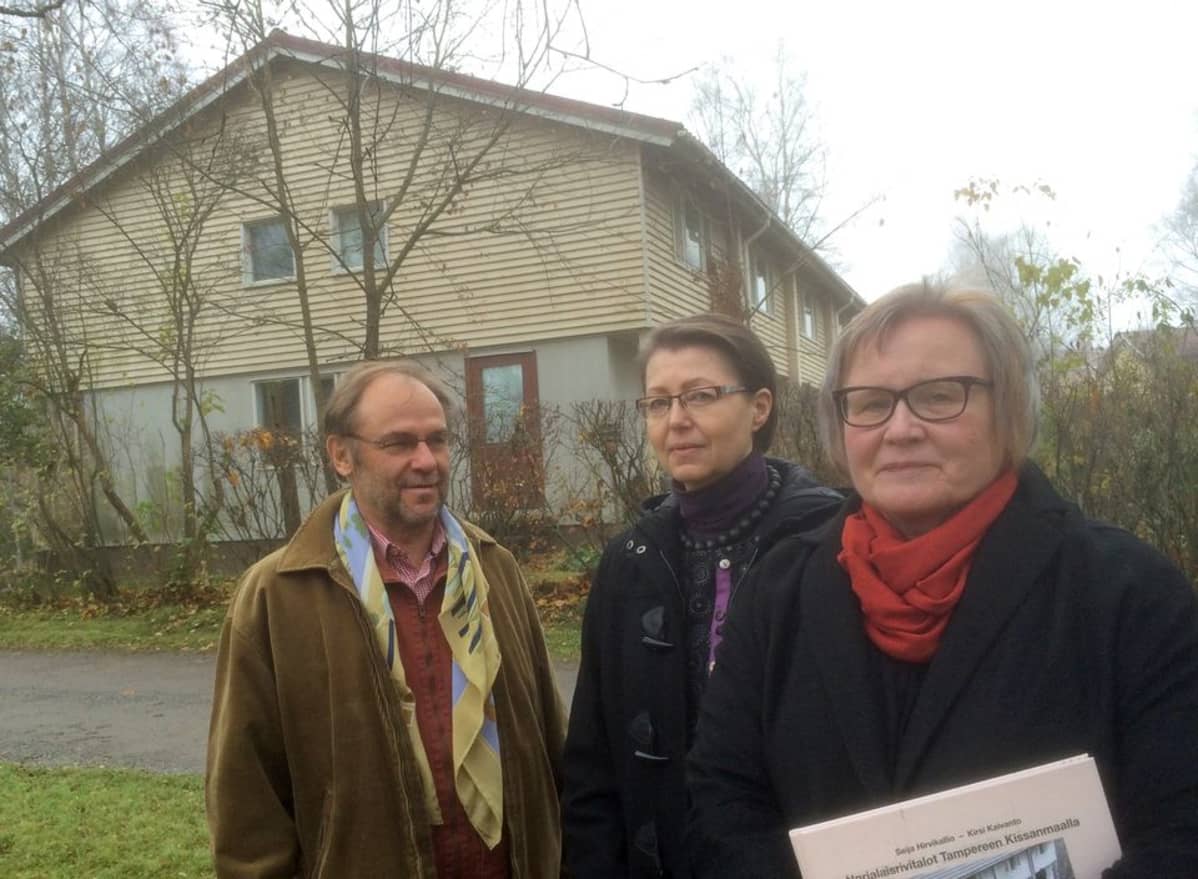 Kalle Heiska, Kirsi Kaivanto ja Seija Hirvikallio kaksikerroksisen rivitalon edessä