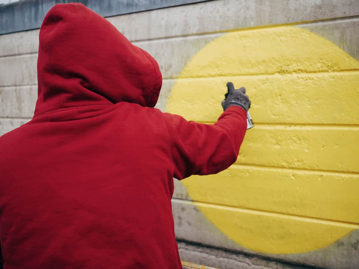 Graffititaiteilija EGS maalaa.
