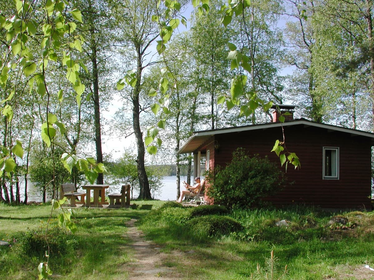 Mökki järven rannalla.