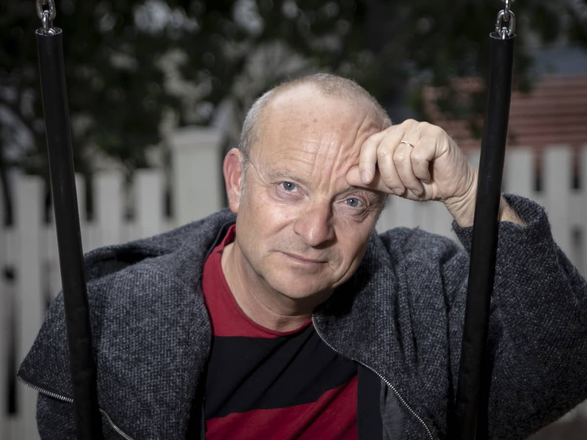 Jonas Gardell istuu keinussa Helsingissä.
