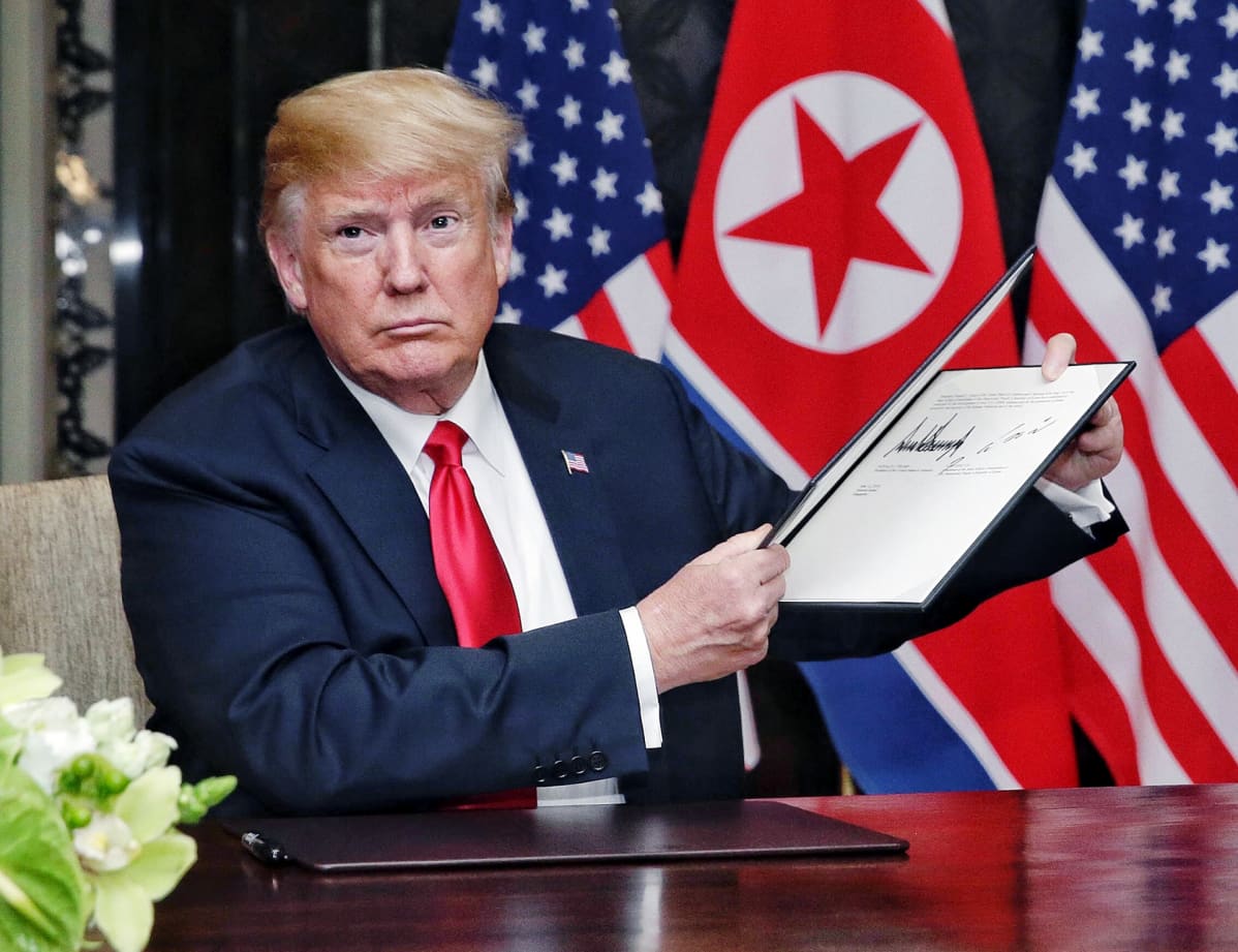 Donald Trump esittelee allekirjoittamaansa asiakirjaa Singaporessa.