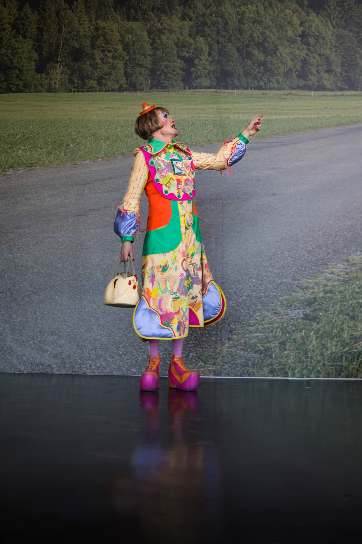Grayson Perry pukeutui vielä jokin aika sitten kuin paimentyttö. Asu on edelleen lapsenomainainen, mutta tuo nyt enemmän mieleen klovnin. Kengät sen tekevät. Niissä on paksu pohja ja epämukavat kävellä.