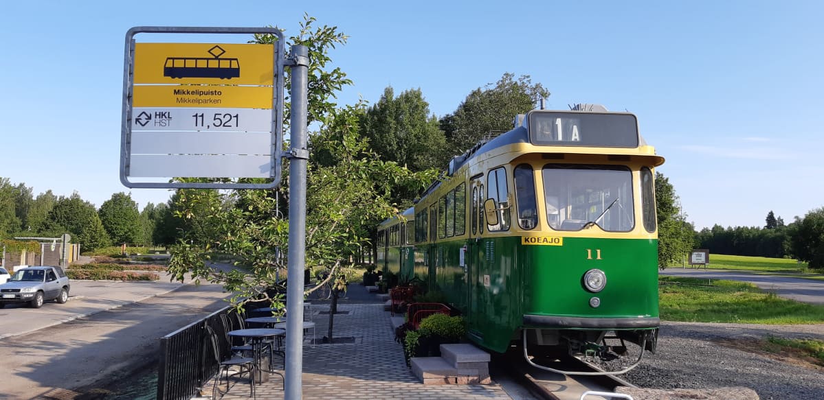 Vanha raitiovaunu 1950-luvulta Mikkelipuistossa ja vieressä raitiovaunun merkki.