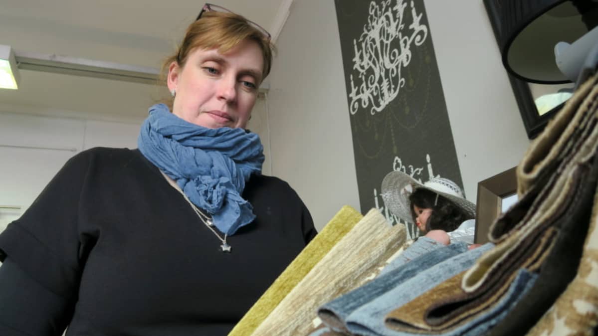 Mervi Nieminen tarkastelee kangasnäytteitä