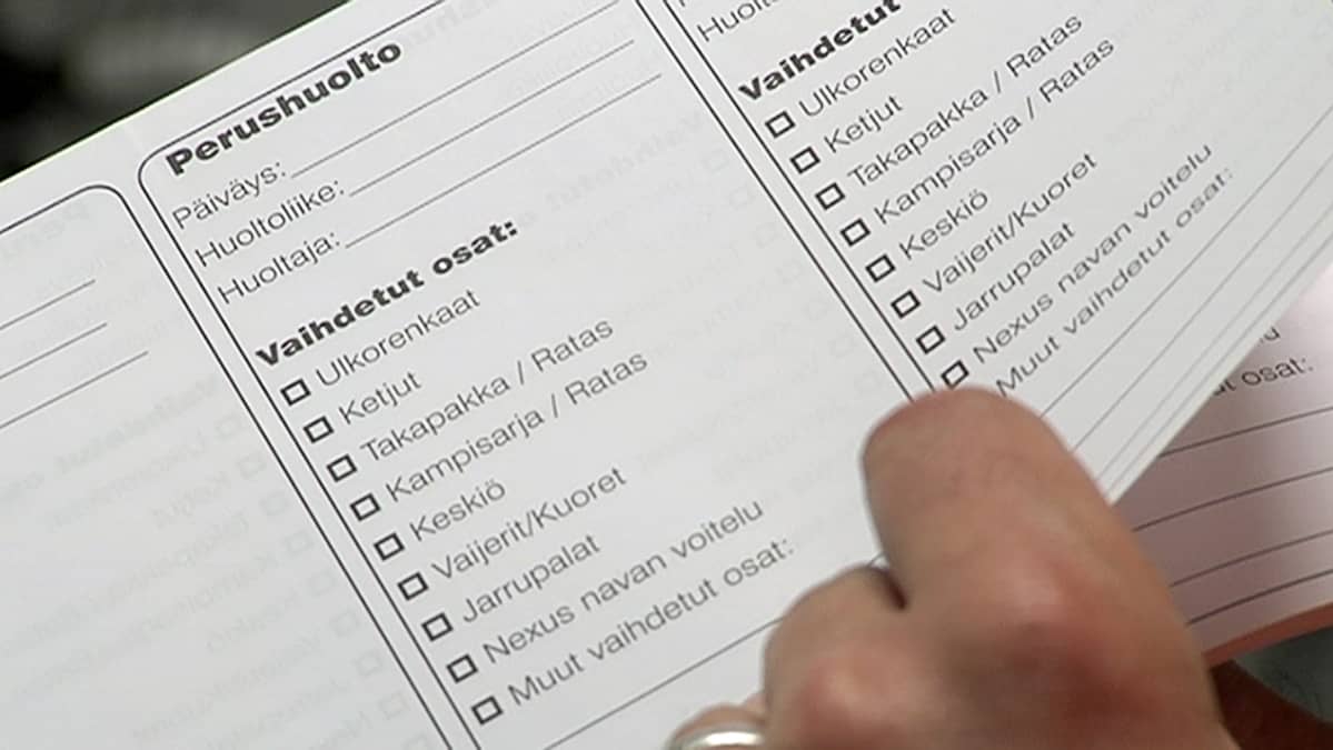 Henkilö selailee polkupyörän huoltokirjaa.