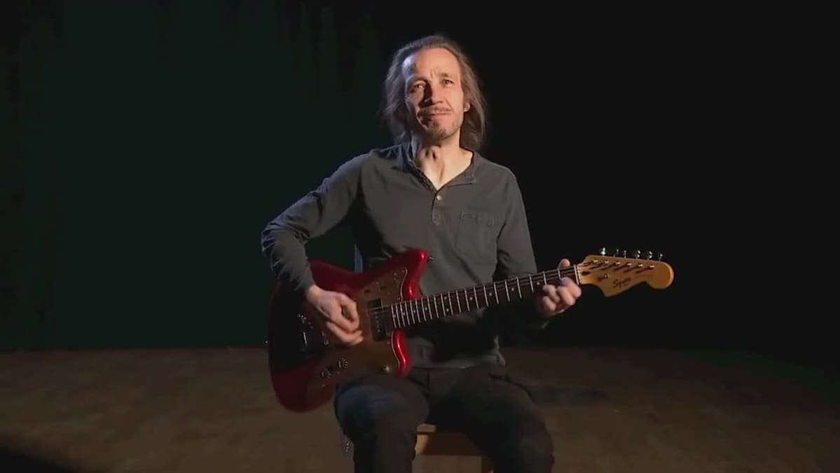 Musician Jarkko Martikainen plays guitar.