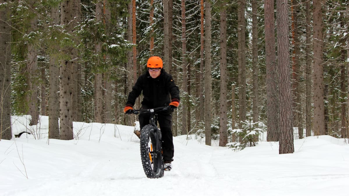 Läskipyöräilijä talvisissa maisemissa