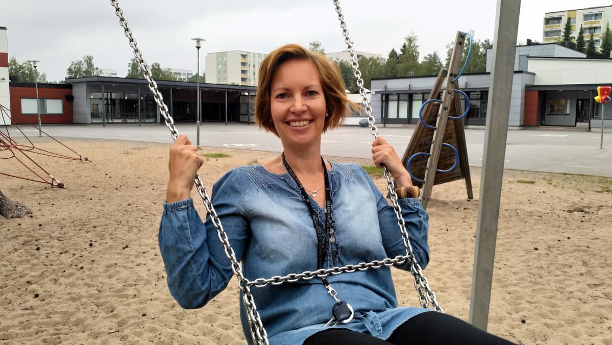 Kuvassa Anne Tuukkanen keinuu Koivuhaan uuden koulun pihalla