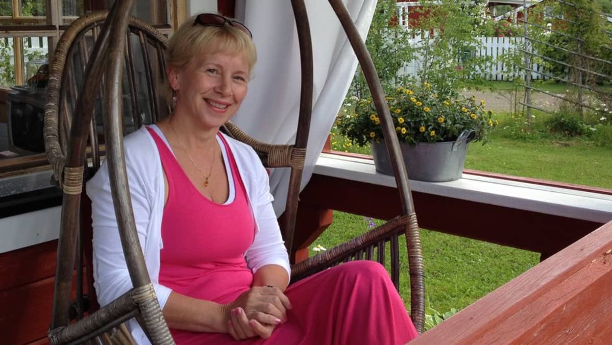 Aila Nuopponen lempipaikassaan korituolissa terassilla.