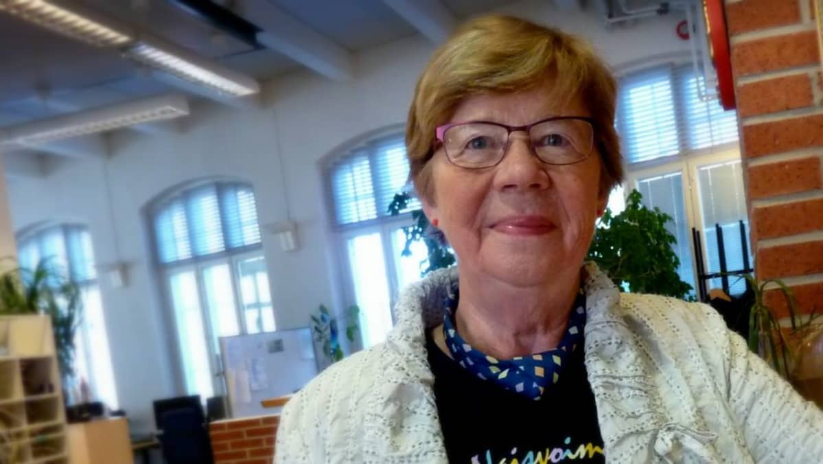 Nainen katsoo kameraan