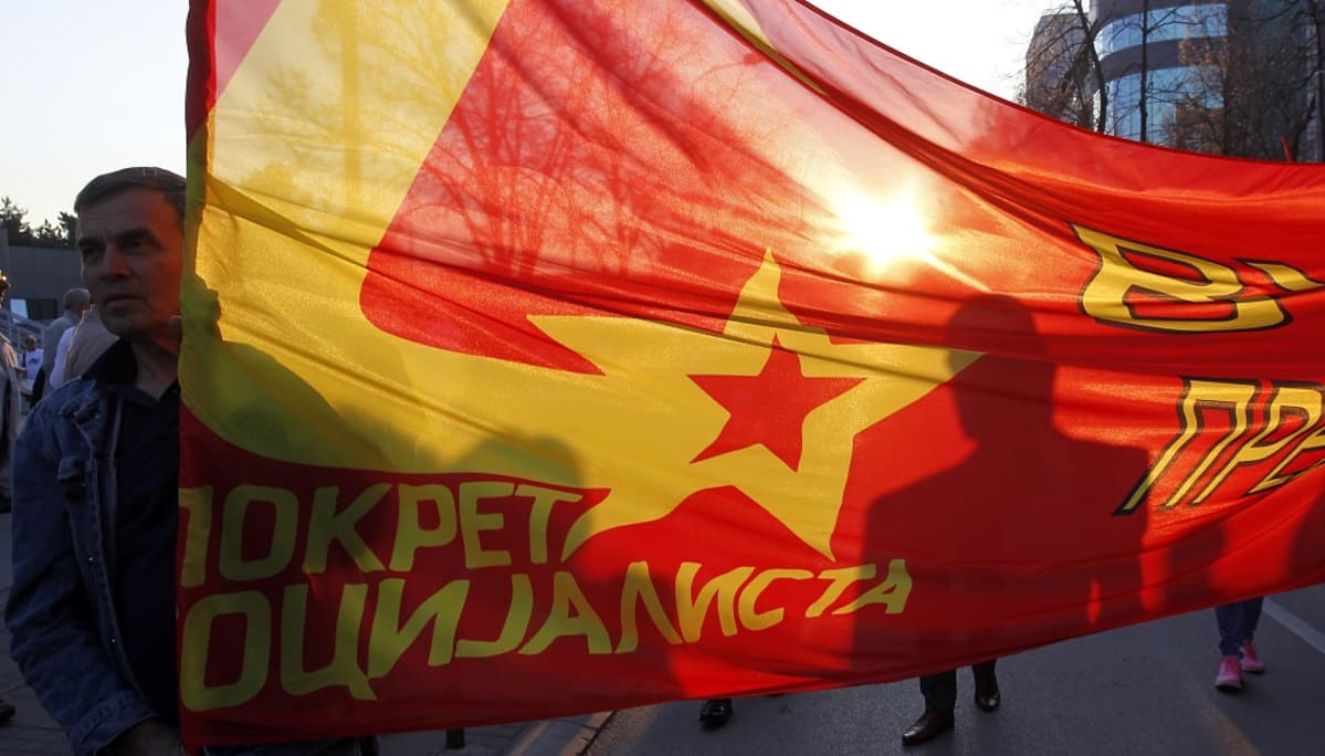 punaista lippua kantavia mielenosoittajia Nisissa Serbiassa.