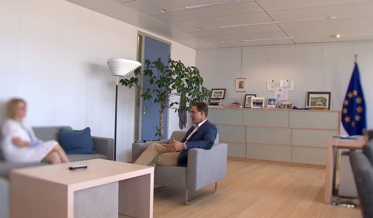 Jyrki Katainen keskustelee toimittajan kanssa toimistossaan.