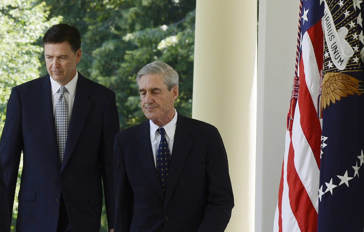 James Comey (vas.) ja Robert Mueller kävelevät Valkoisen talon pihalla.