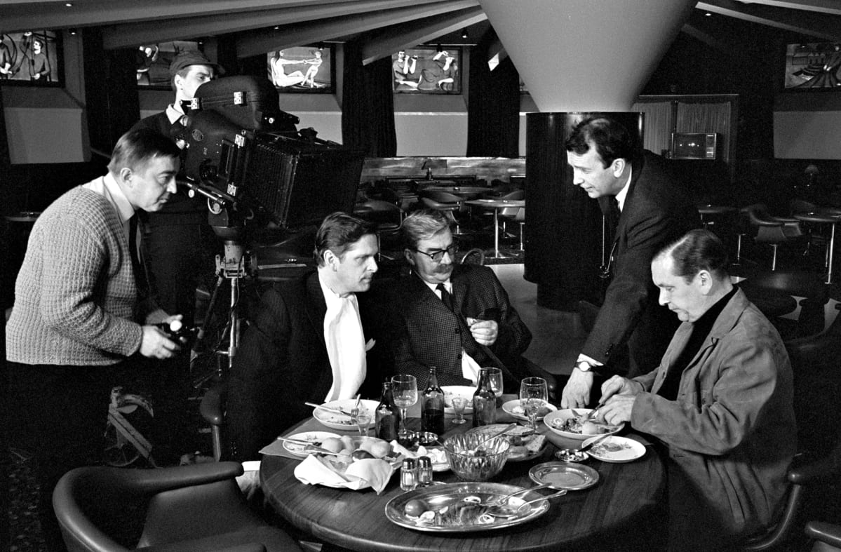 Mika Waltarin luoman Komisario Palmu -hahmon filmatisointikaarti pöydän ääressä Kalastajatorpalla vas. Matti Ranin, Joel Rinne (Palmun hahmossa), ohjaaja Matti Kassila ja Leo Jokela (Kokki) filmaamassa neljättä eli viimeistä "Vodkaa, komisario Palmu" -elokuvaa 9. huhtikuuta 1969.