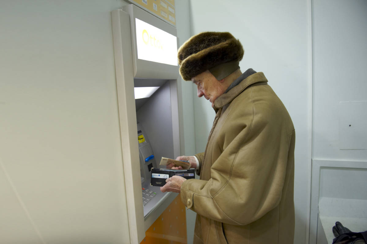 vanhus pankkiautomaatilla