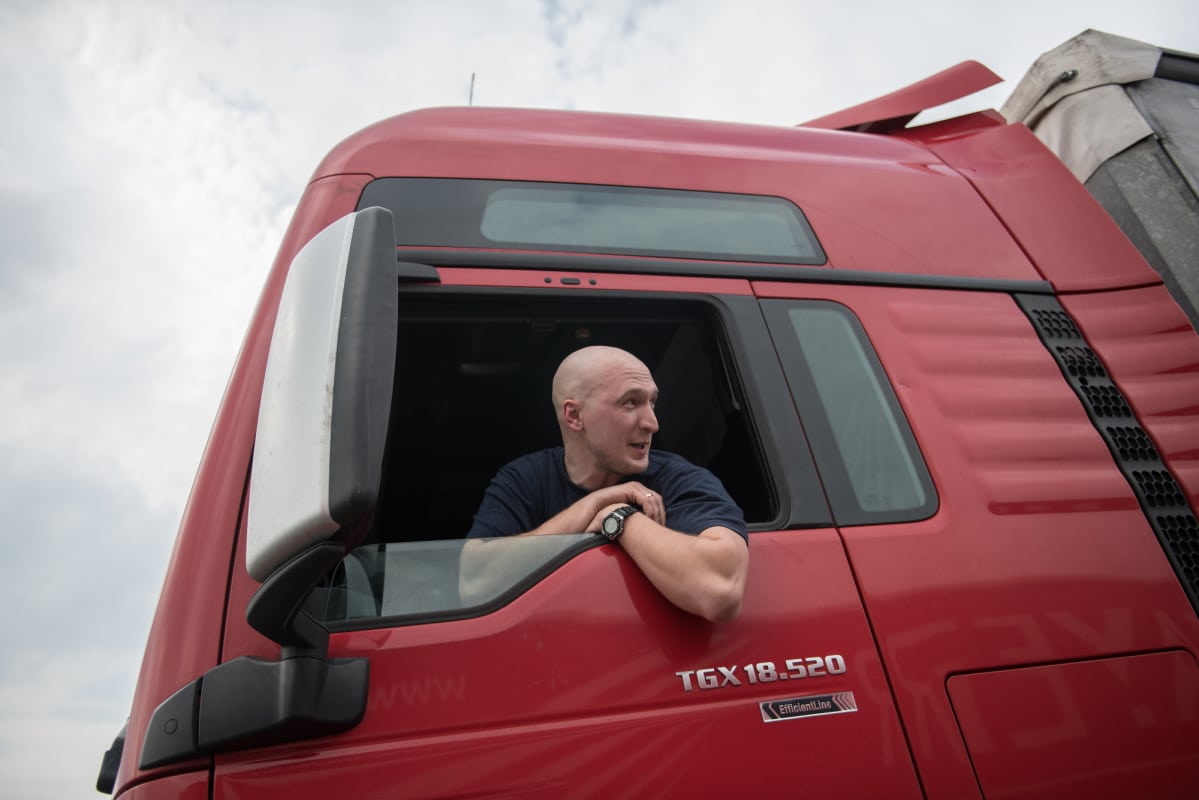 Mindaugas Lukaskas katsoo ulos kuljettajan ikkunasta kuorma-autostaan.