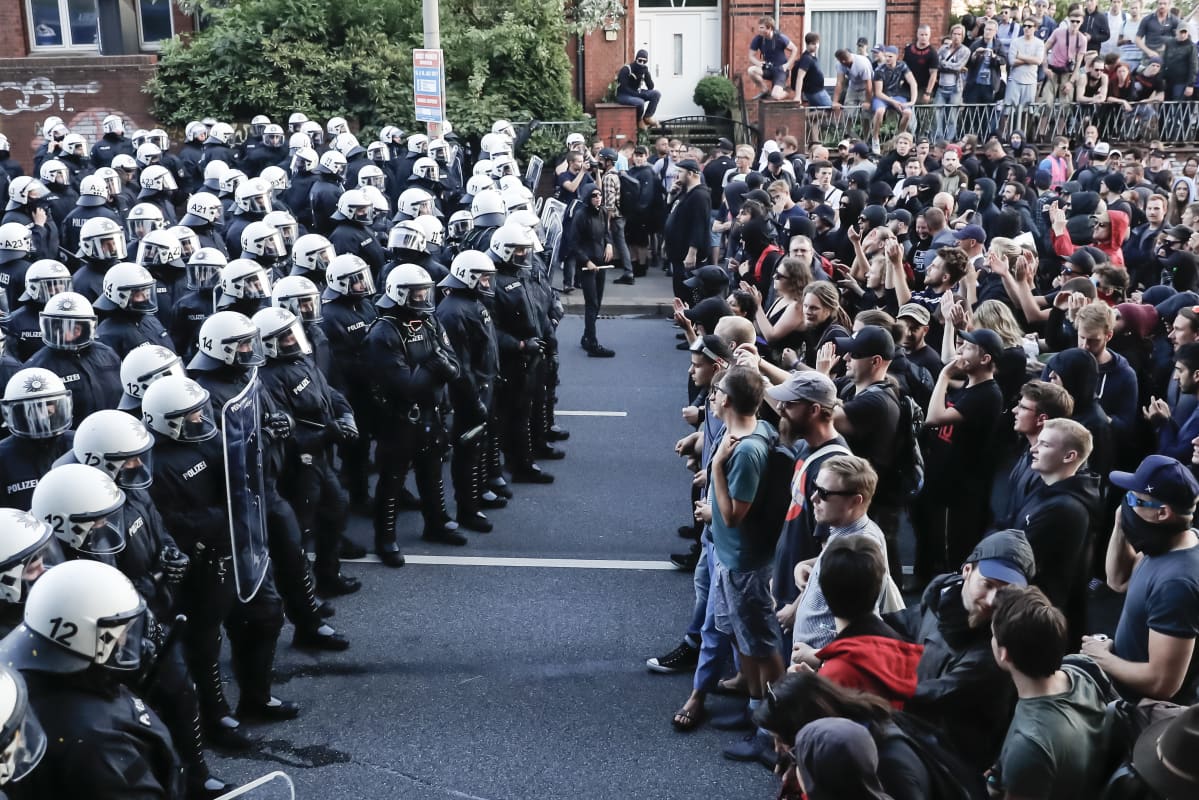 Protestors (R) and policemen stand face to face during the demonstration 'Welcome to Hell' ahead of the G20 summit in Hamburg, Germany, 06 July 2017.