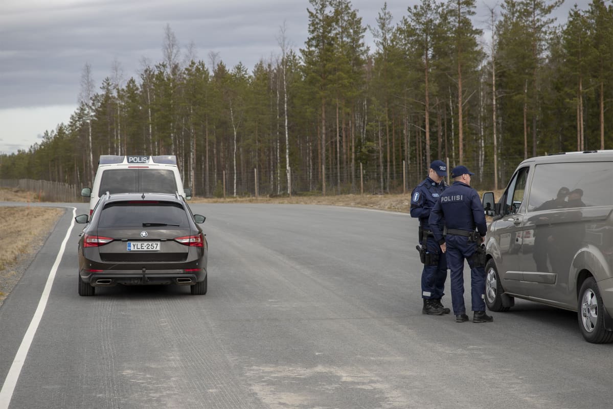 Poliisit keskustelevat pysäytetyn auton kuljettajan kanssa
