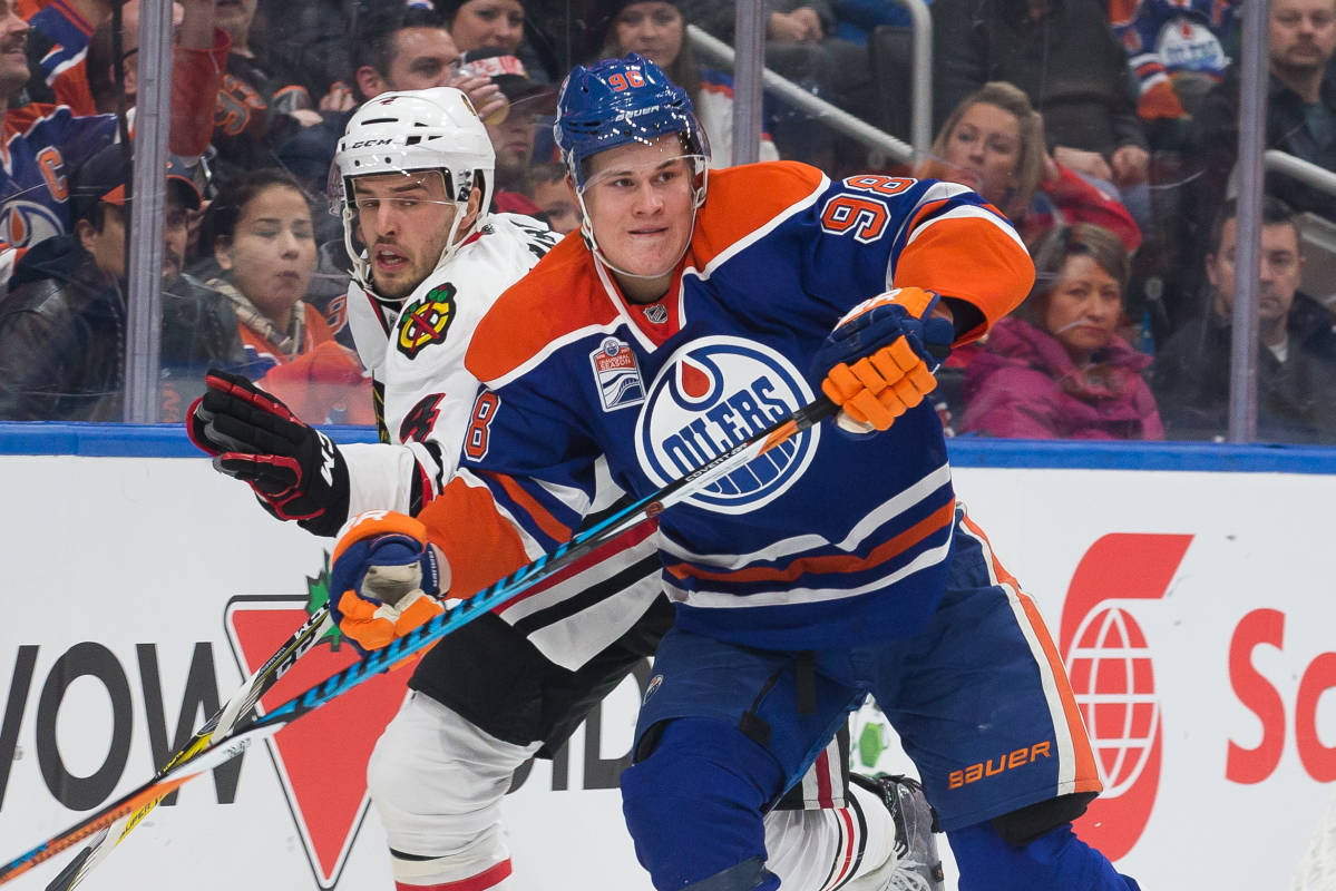 Edmontonin Jesse Puljujärvi kamppailee NHL-kaukalossa Chicago-puolustaja Niklas Hjalmarssonin kanssa.
