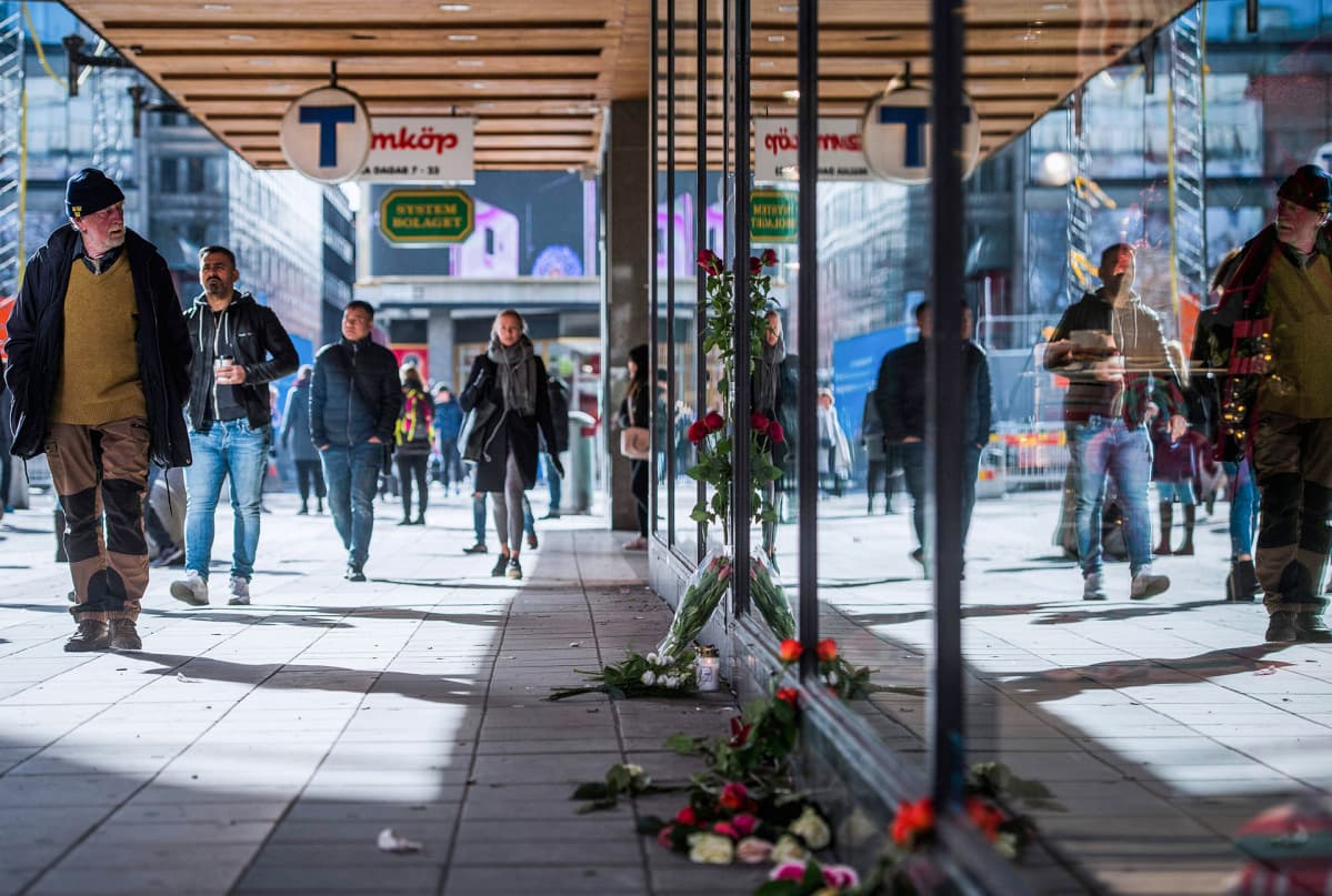 tavaratalon seinän juureen on tuotu kukkia