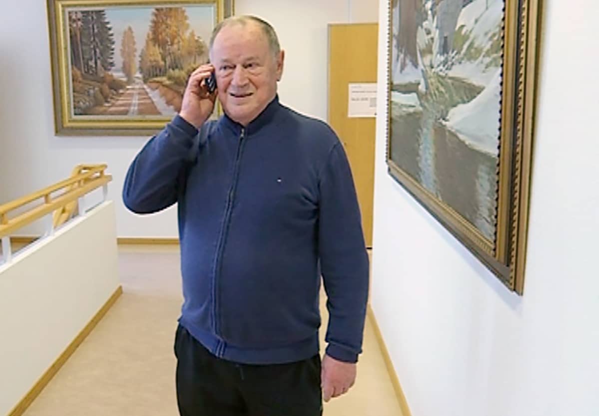 Heikki Paukkula puhuu kännykkäänsä.