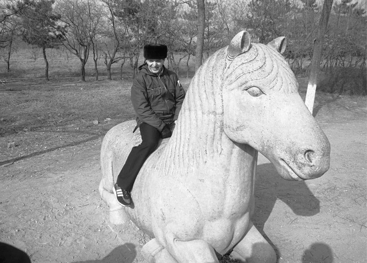 Ulkoministeri Paavo Väyrynen istuu kivihevosen selässä Ming-dynastian haudoilla Pekingissä.