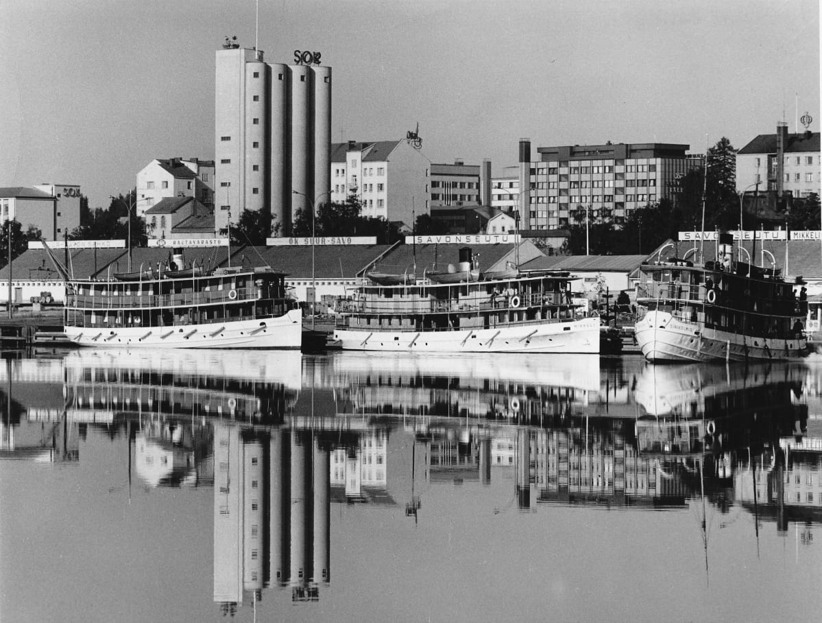 Mikkelin satamaa Saimaalta kuvattuna vuonna 1968. Taustalla Mikkelin keskustan rakennuksia, edustalla
kolme matkustajalaivaa satamassa.