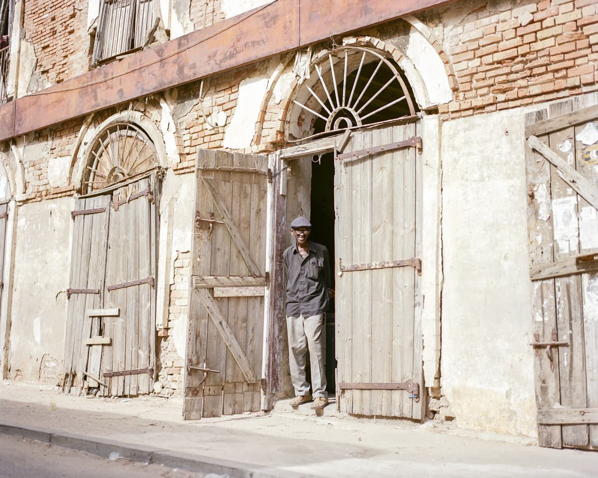 Souleymane Seye seisoo kaksikerroksisen talon edustalla.