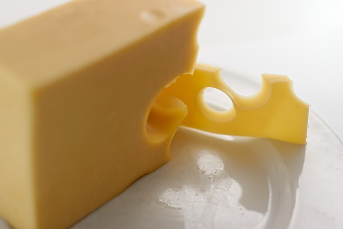 A block and slice of cheese.