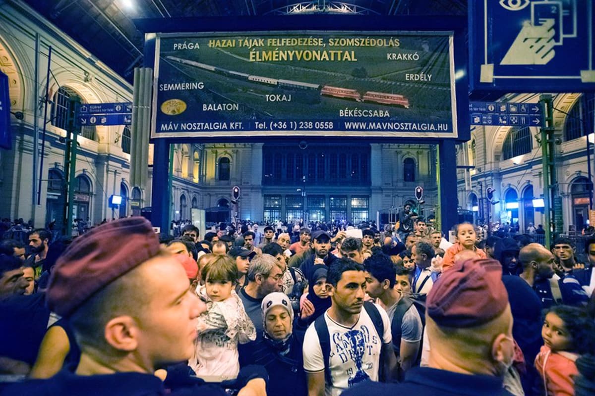 Siirtolaiset odottavat Saksaan lähtevää junaa Budapestin Keletin asemalla.
