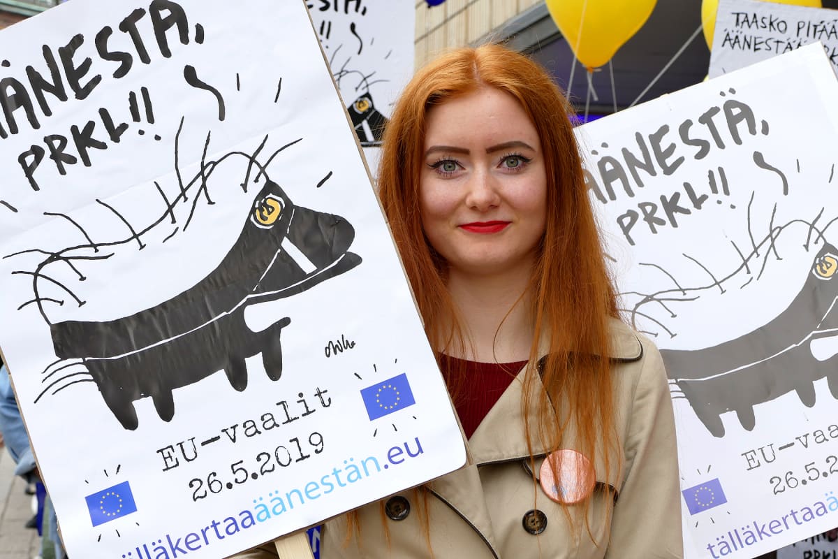 Opiskelija vaalikylttien seassa.