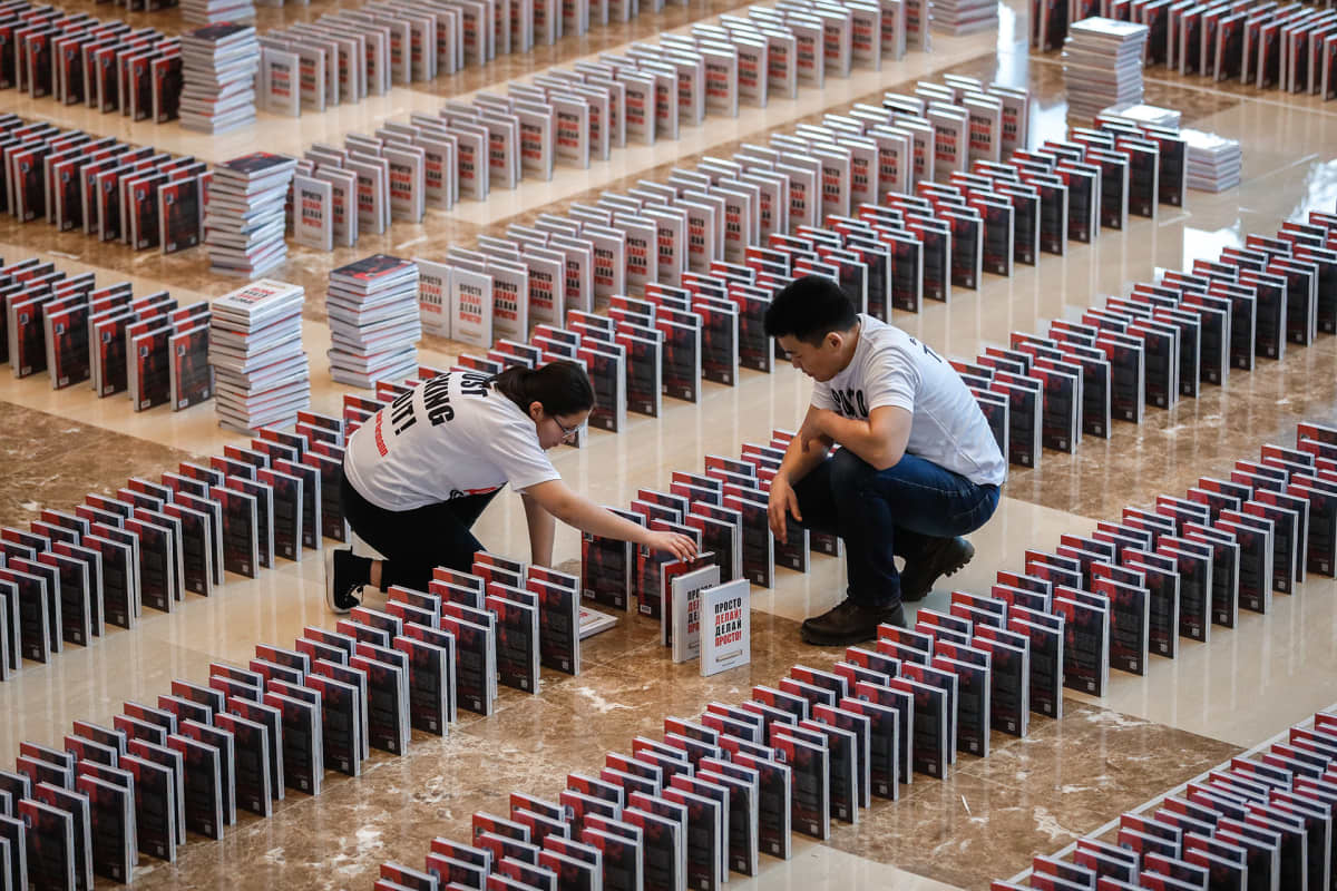 People install a domino books titled 'Just do it! Do it easy!' by German-Russian businessman Oskar Hartmann prior to attempt to set the book dominoes world record in Moscow, Russia, 14 February 2020. All 15,000 books toppled in the dominoes.